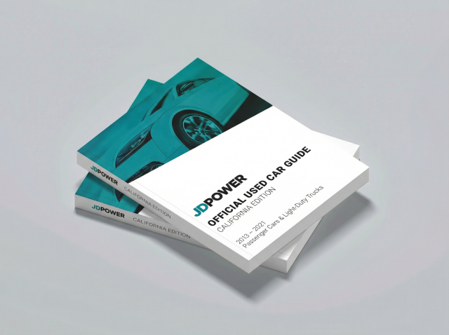 A used car guide book featuring the new JD Power logo and teal design guide